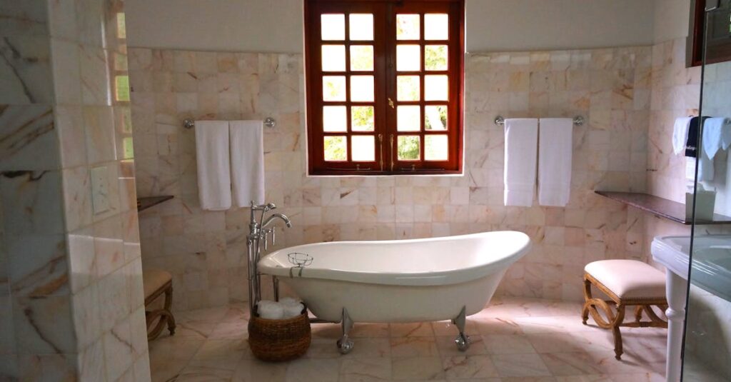 White Bathtub on White Tile Bathroom Near Brown Framed Clear Glass Window